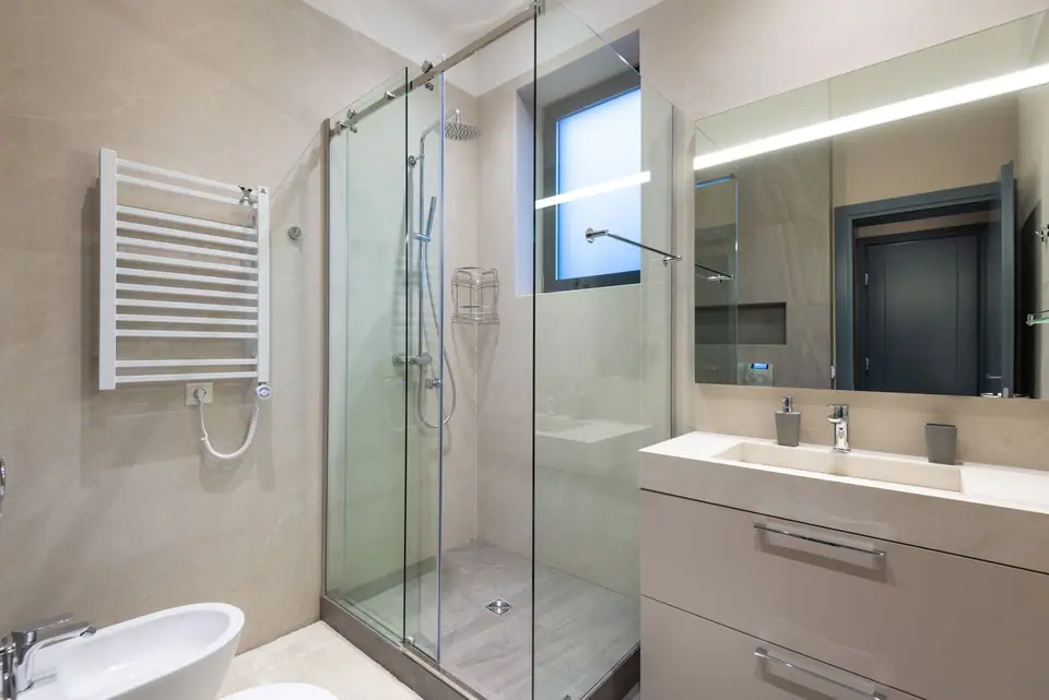 New bathroom with heated towel rail and vanity unit