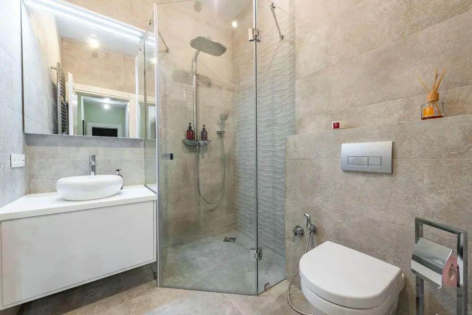 Finished shower room with walk-in glass shower and wall-hung toilet