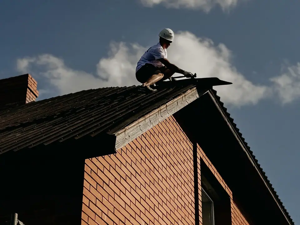 Roof repair on a red brick house