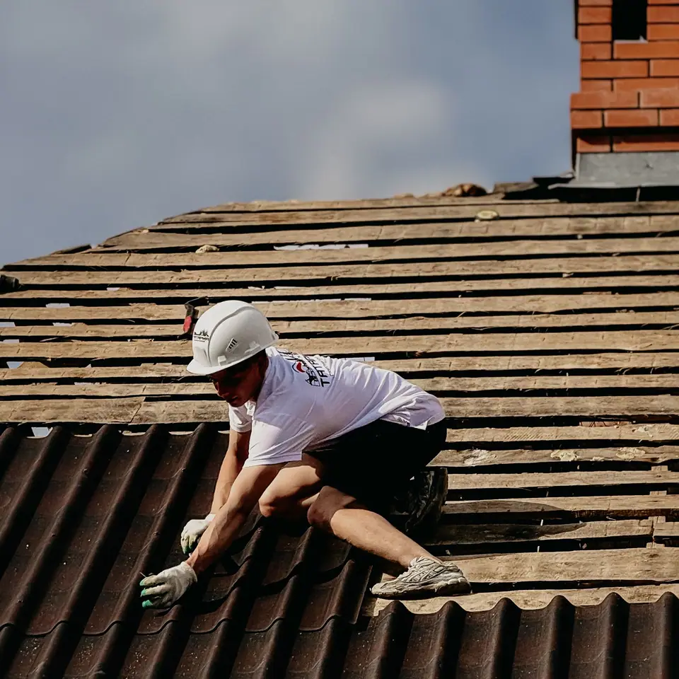 Roofer working safely on a pitched roof