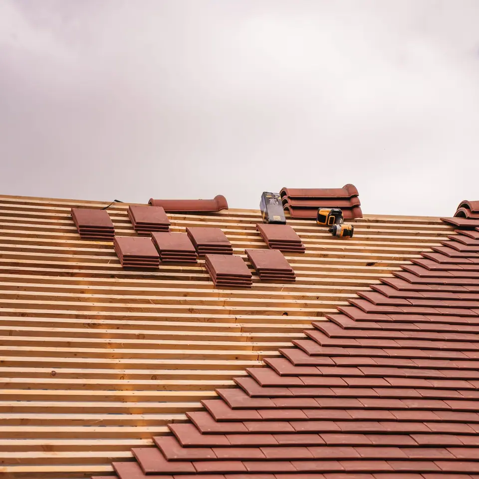 Clay tile roof part way through a re-roof